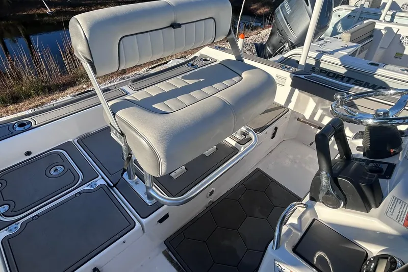 Slide: The Image of 2019 Yamaha Boats 210 FSH Sport interior with seating and steering console. - 14