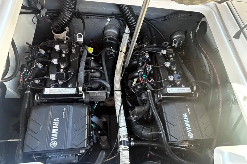 Slide: The Image of Engine compartment of 2019 Yamaha Boats 210 FSH Sport, showcasing dual Yamaha TR-1 engines. - 15