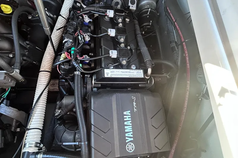 Slide: The Image of Engine compartment of a 2019 Yamaha Boats 210 FSH Sport, showcasing detailed components. - 17