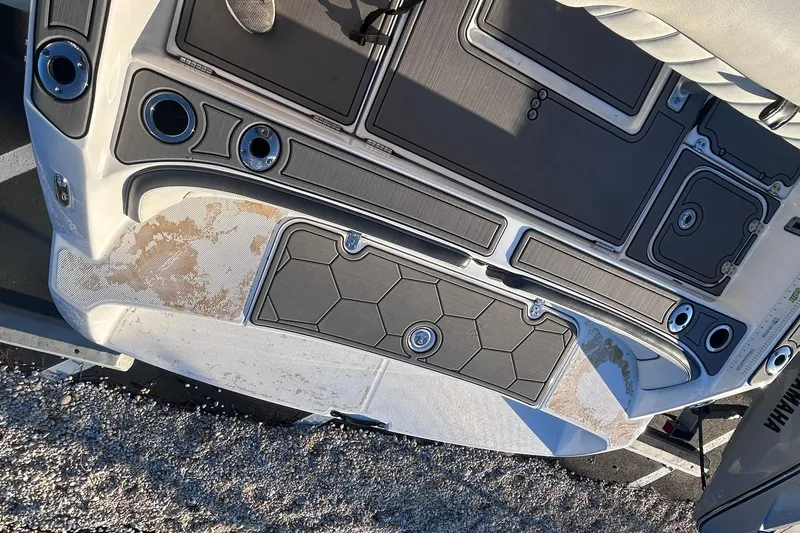 Slide: The Image of 2019 Yamaha Boats 210 FSH Sport deck with storage compartments and cup holders. - 18