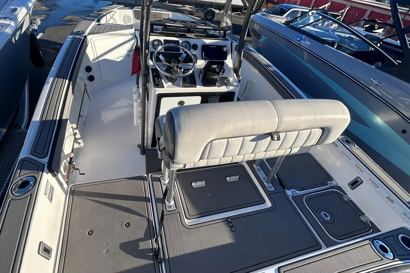 Slide: The Image of 2019 Yamaha Boats 210 FSH Sport interior with helm and seating area. - 19