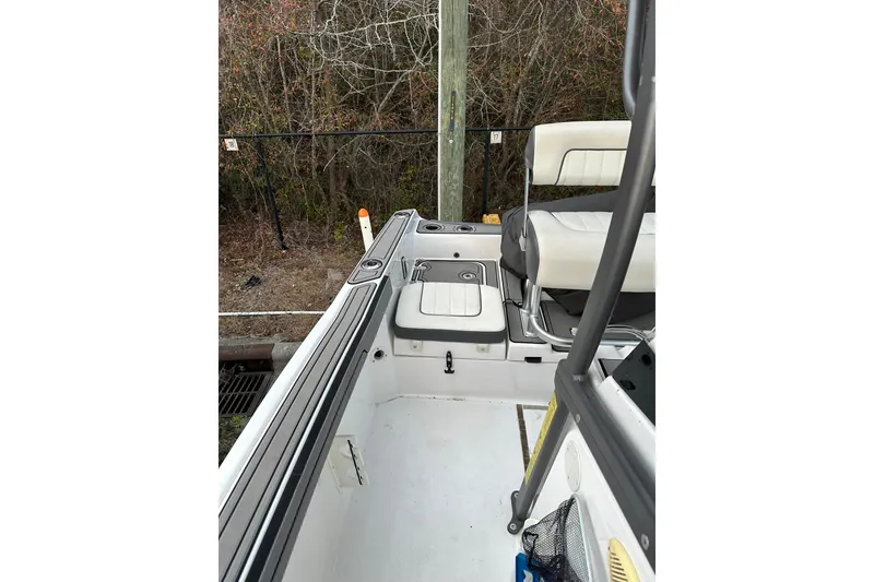 Slide: The Image of 2019 Yamaha Boats 210 FSH Sport interior with seating and storage compartments. - 21