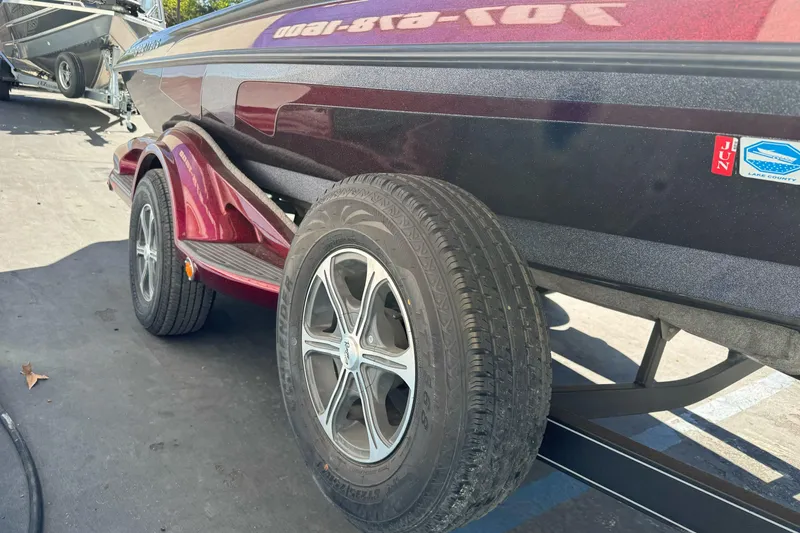 Slide: The Image of 2010 Ranger 178 VS boat trailer with red accents and visible tire. - 5