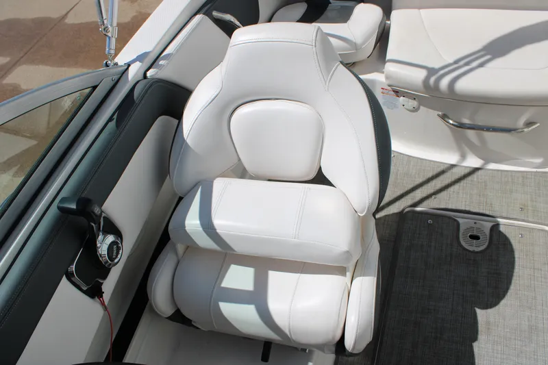 Slide: The Image of 2021 Chaparral 19 SSi Ski & Fish boat interior with white seating and control panel. - 16