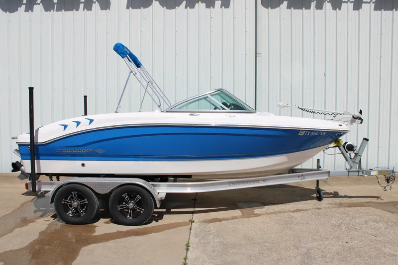 Slide: The Image of 2021 Chaparral 19 SSi Ski & Fish boat on trailer, blue and white design. - 2