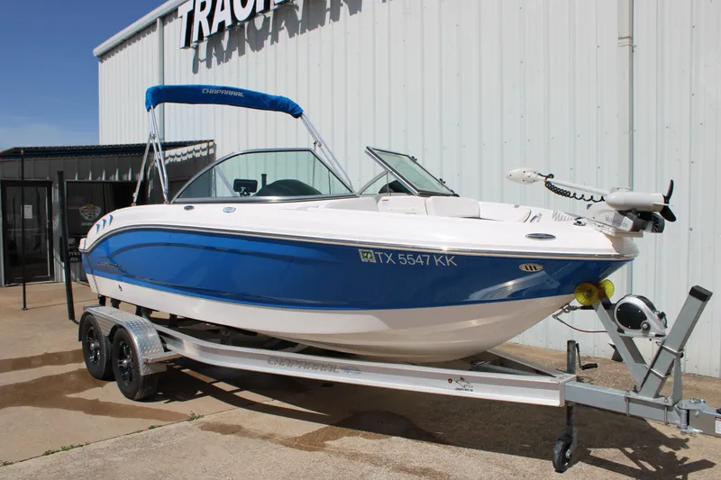 Slide: The Image of 2021 Chaparral 19 SSi Ski & Fish boat on trailer, blue and white design. - 25