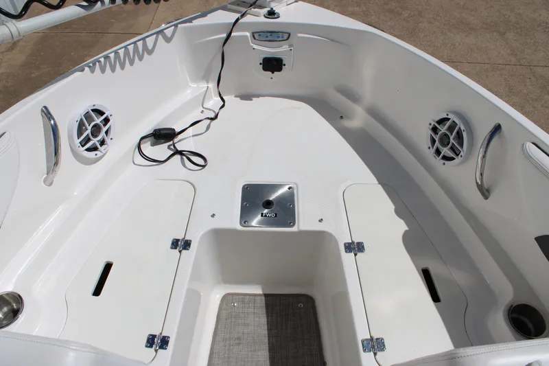 Slide: The Image of 2021 Chaparral 19 SSi Ski & Fish boat interior with storage compartments and speakers. - 7