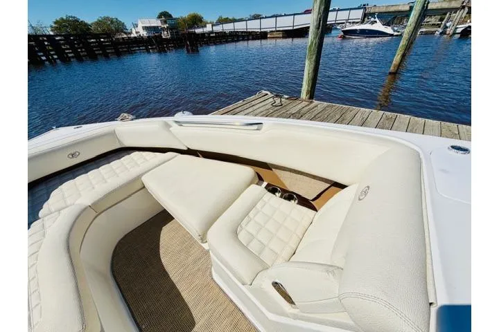 Slide: The Image of 2017 Cobalt R7 boat with white leather seating docked by the water. - 20