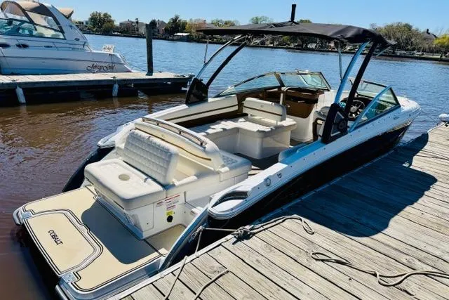 Slide: The Image of 2017 Cobalt R7 boat docked, featuring spacious seating and sleek design. - 4