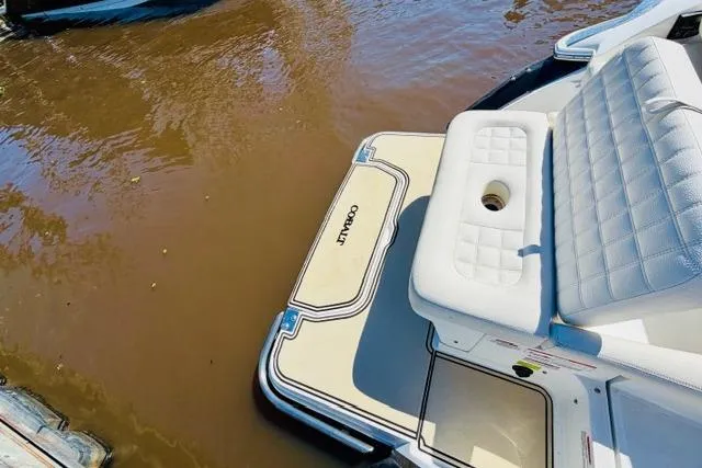 Slide: The Image of 2017 Cobalt R7 boat with white seating and swim platform on brown water. - 7