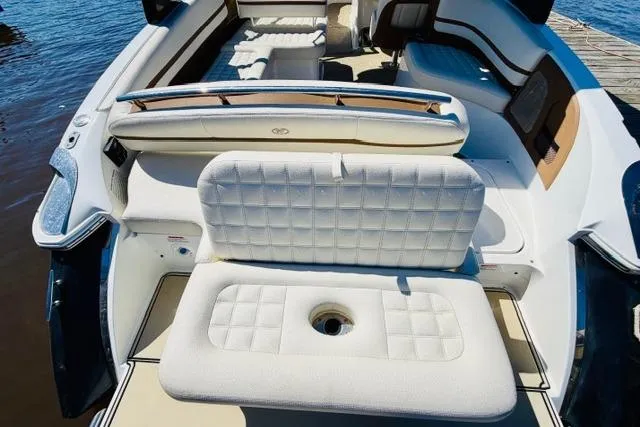 Slide: The Image of 2017 Cobalt R7 boat interior with white cushioned seating near water. - 8