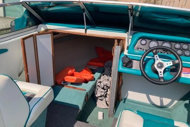 Slide: The Image of 1990 Searay 200 Cuddy boat interior with steering wheel and cabin view. - 3