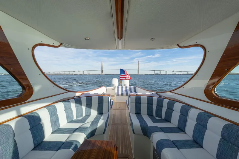 Slide: The Image of Interior view of 2024 Hinckley 35 yacht with striped seating and ocean backdrop. - 15