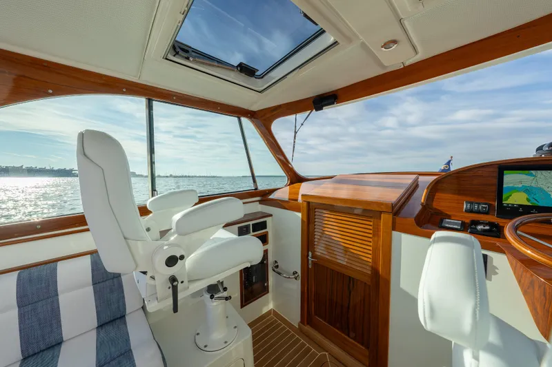 Slide: The Image of Interior of 2024 Hinckley 35 yacht with luxurious seating and navigation system. - 22