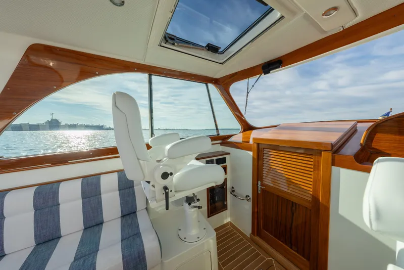 Slide: The Image of Interior of 2024 Hinckley 35 yacht with elegant wood finish and ocean view. - 23