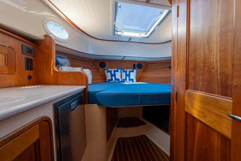Slide: The Image of Luxurious cabin interior of 2024 Hinckley 35 yacht with wood finish and skylight. - 28