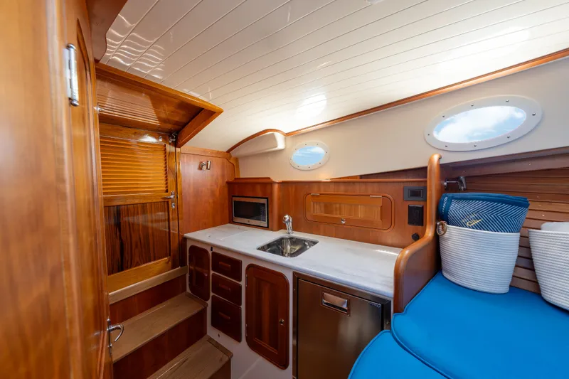 Slide: The Image of Luxurious interior of 2024 Hinckley 35 yacht with wooden cabinetry and modern amenities. - 29