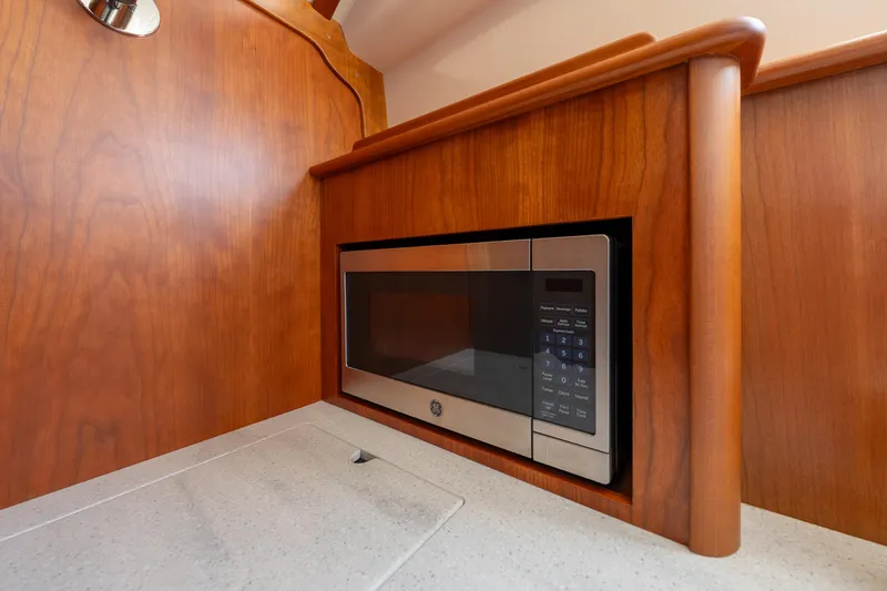 Slide: The Image of Built-in microwave in 2024 Hinckley 35 yacht's wooden interior kitchen. - 30