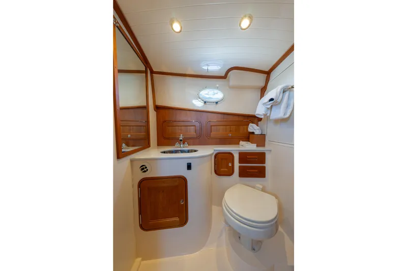 Slide: The Image of Luxurious 2024 Hinckley 35 yacht bathroom with wood accents and modern fixtures. - 31