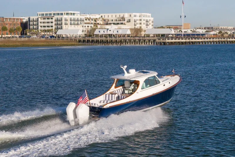 Slide: The Image of 2024 Hinckley 35 cruising on water near urban waterfront buildings. - 34