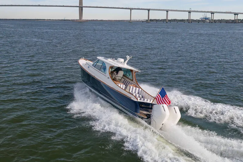 Slide: The Image of 2024 Hinckley 35 yacht cruising under a bridge on open water. - 6