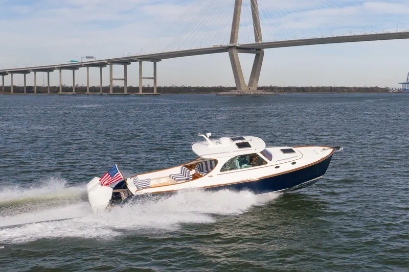 Slide: The Image of 2024 Hinckley 35 yacht cruising under a bridge on a sunny day. - 8