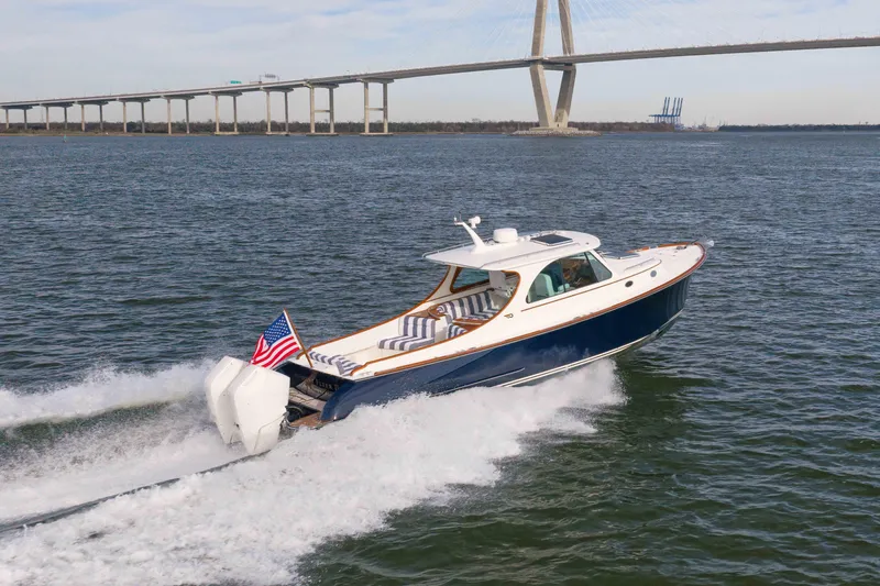 Slide: The Image of 2024 Hinckley 35 yacht cruising on water near a large bridge. - 9