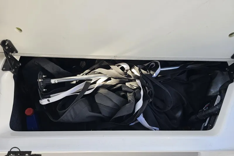 Slide: The Image of Storage compartment of 2017 Yamaha Boats 242X E-Series with equipment and gear. - 102