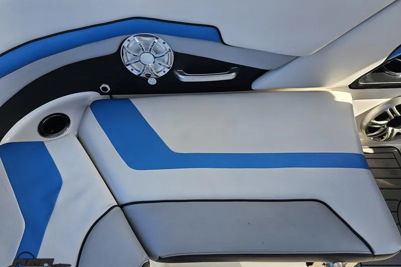 Slide: The Image of 2017 Yamaha Boats 242X E-Series interior with blue and white seating and speaker detail. - 107