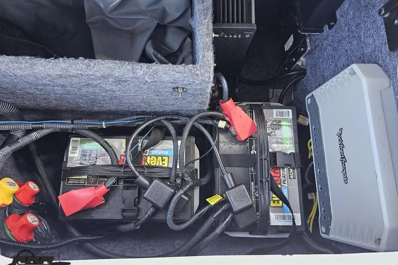 Slide: The Image of Battery compartment of a 2017 Yamaha Boats 242X E-Series with wiring and components. - 108