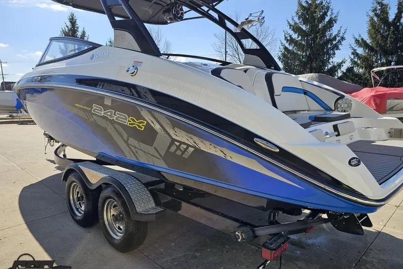 Slide: The Image of 2017 Yamaha Boats 242X E-Series on trailer, sleek design, blue and white color scheme. - 28