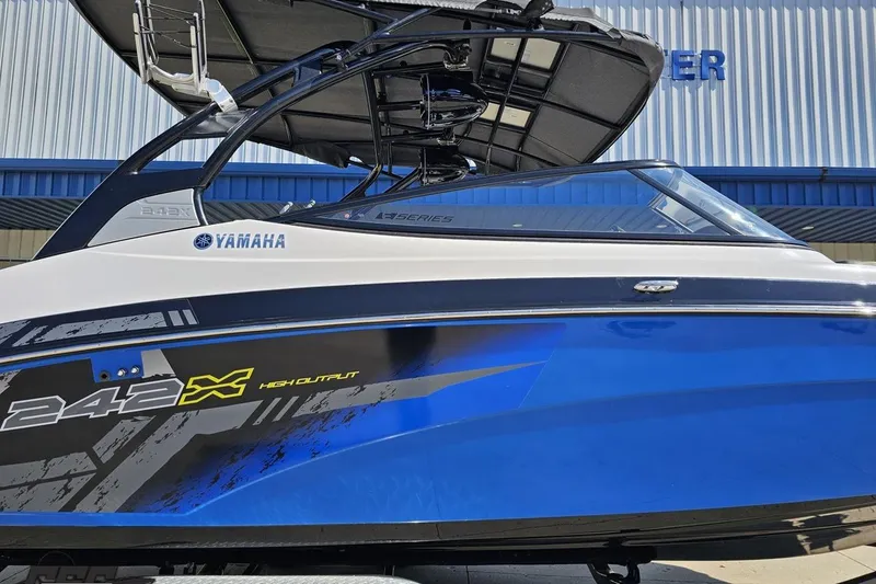 Slide: The Image of 2017 Yamaha Boats 242X E-Series, blue and white, high output model, side view. - 3
