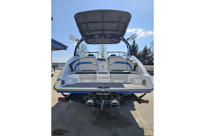 Slide: The Image of 2017 Yamaha Boats 242X E-Series, rear view, docked under clear blue sky. - 31