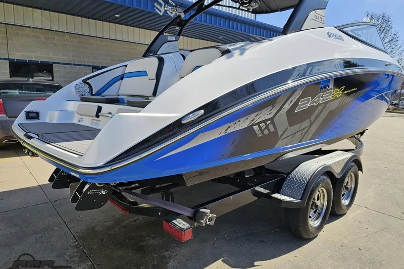 Slide: The Image of 2017 Yamaha Boats 242X E-Series on trailer, showcasing sleek design and vibrant blue accents. - 33