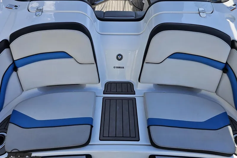 Slide: The Image of 2017 Yamaha Boats 242X E-Series interior seating with blue and white upholstery. - 36