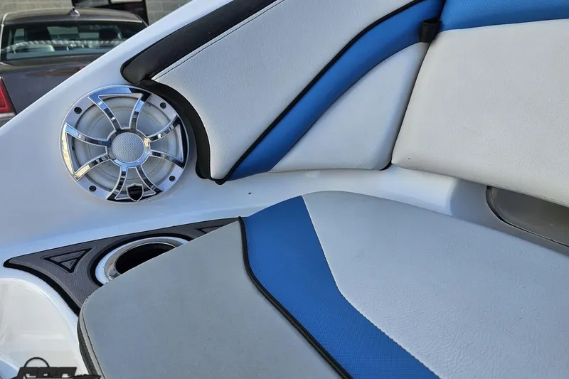 Slide: The Image of 2017 Yamaha Boats 242X E-Series interior with blue and white seating and speaker detail. - 43