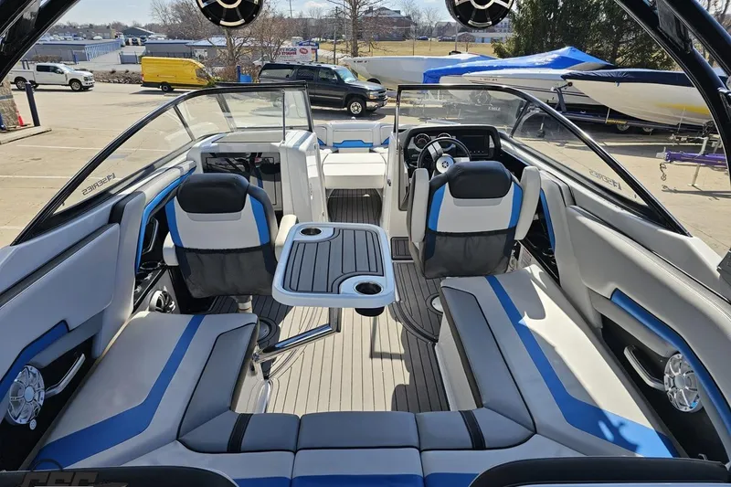 Slide: The Image of 2017 Yamaha Boats 242X E-Series interior with blue and white seating, steering wheel, and table. - 45