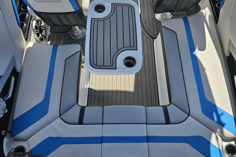 Slide: The Image of 2017 Yamaha Boats 242X E-Series interior with blue-accented seating and central table. - 52