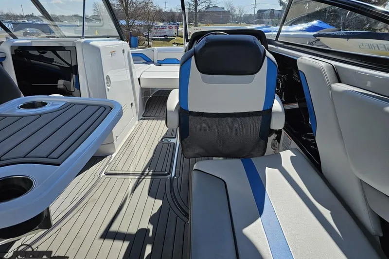 Slide: The Image of Interior of 2017 Yamaha Boats 242X E-Series, featuring seating and table with cup holders. - 57