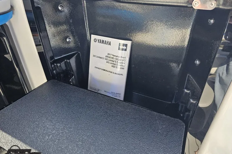Slide: The Image of Owner's manual for 2017 Yamaha Boats 242X E-Series, displayed in a storage compartment. - 63