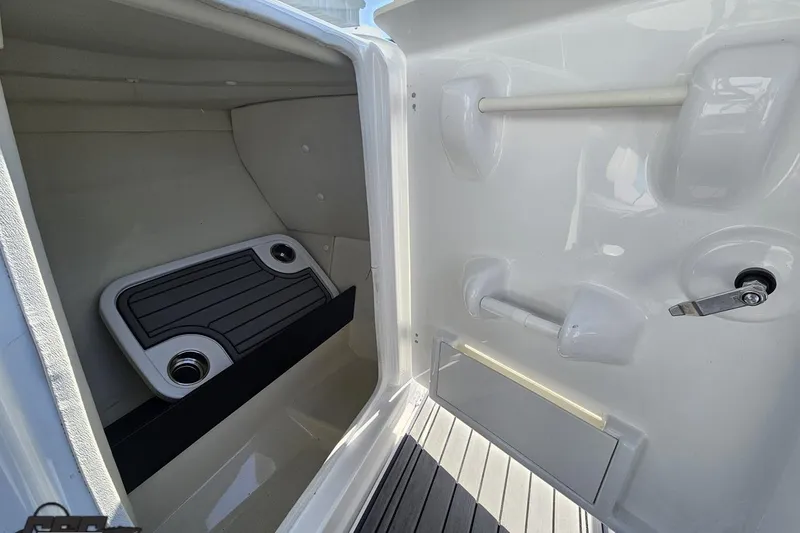Slide: The Image of Interior storage compartment of 2017 Yamaha Boats 242X E-Series, featuring cup holders and sleek design. - 64