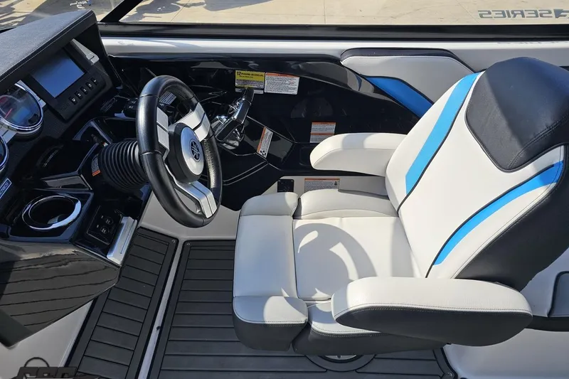 Slide: The Image of 2017 Yamaha Boats 242X E-Series cockpit with steering wheel and cushioned seat. - 67
