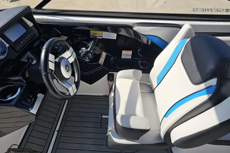 Slide: The Image of 2017 Yamaha Boats 242X E-Series cockpit with steering wheel and captain's seat. - 68