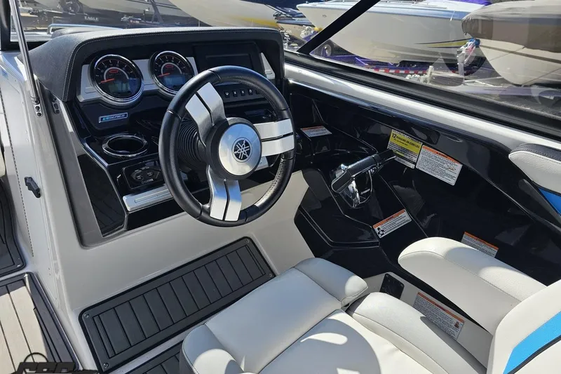 Slide: The Image of 2017 Yamaha Boats 242X E-Series cockpit with steering wheel and controls. - 69