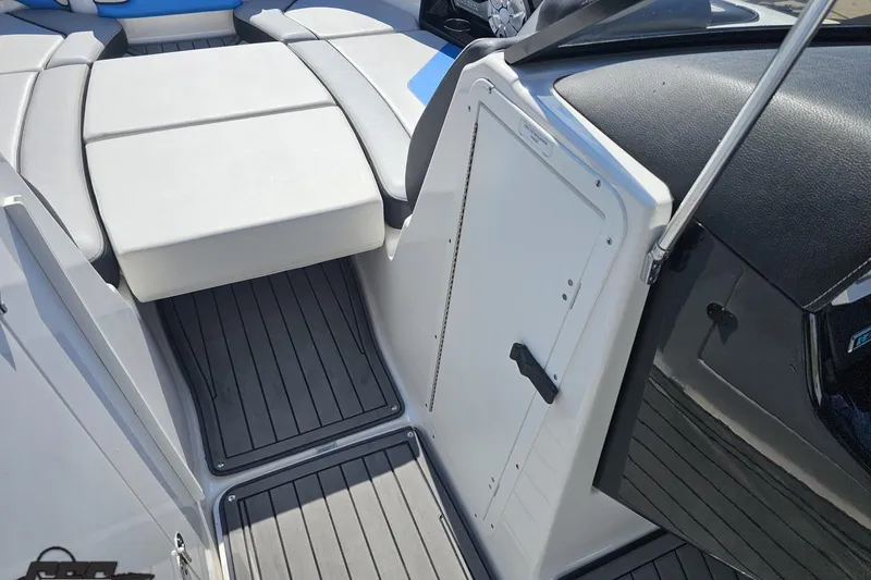 Slide: The Image of 2017 Yamaha Boats 242X E-Series interior with cushioned seating and sleek flooring. - 78