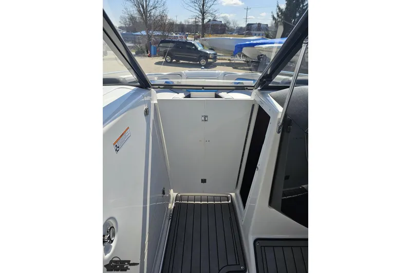 Slide: The Image of 2017 Yamaha Boats 242X E-Series interior with open storage compartment. - 80