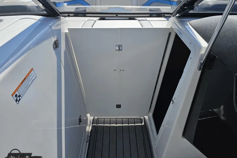 Slide: The Image of Interior view of 2017 Yamaha Boats 242X E-Series, featuring storage compartment and sleek design. - 81