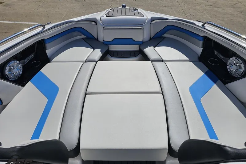 Slide: The Image of 2017 Yamaha Boats 242X E-Series interior with blue and gray seating. - 82