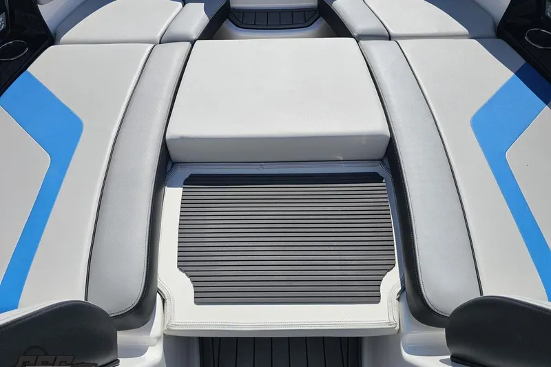Slide: The Image of 2017 Yamaha Boats 242X E-Series interior seating with blue accents and non-slip flooring. - 85