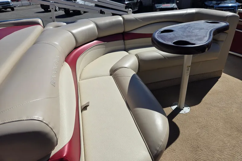 Slide: The Image of Luxurious seating area on a 2010 Bennington 2275RLi pontoon boat with table and cup holders. - 7